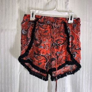 Red paisley shorts with black fringe trim